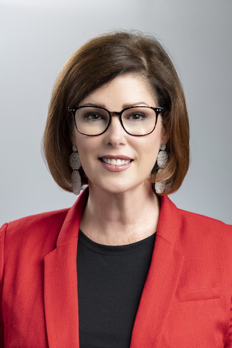 A person wearing glasses and a red jacketAI-generated content may be incorrect.