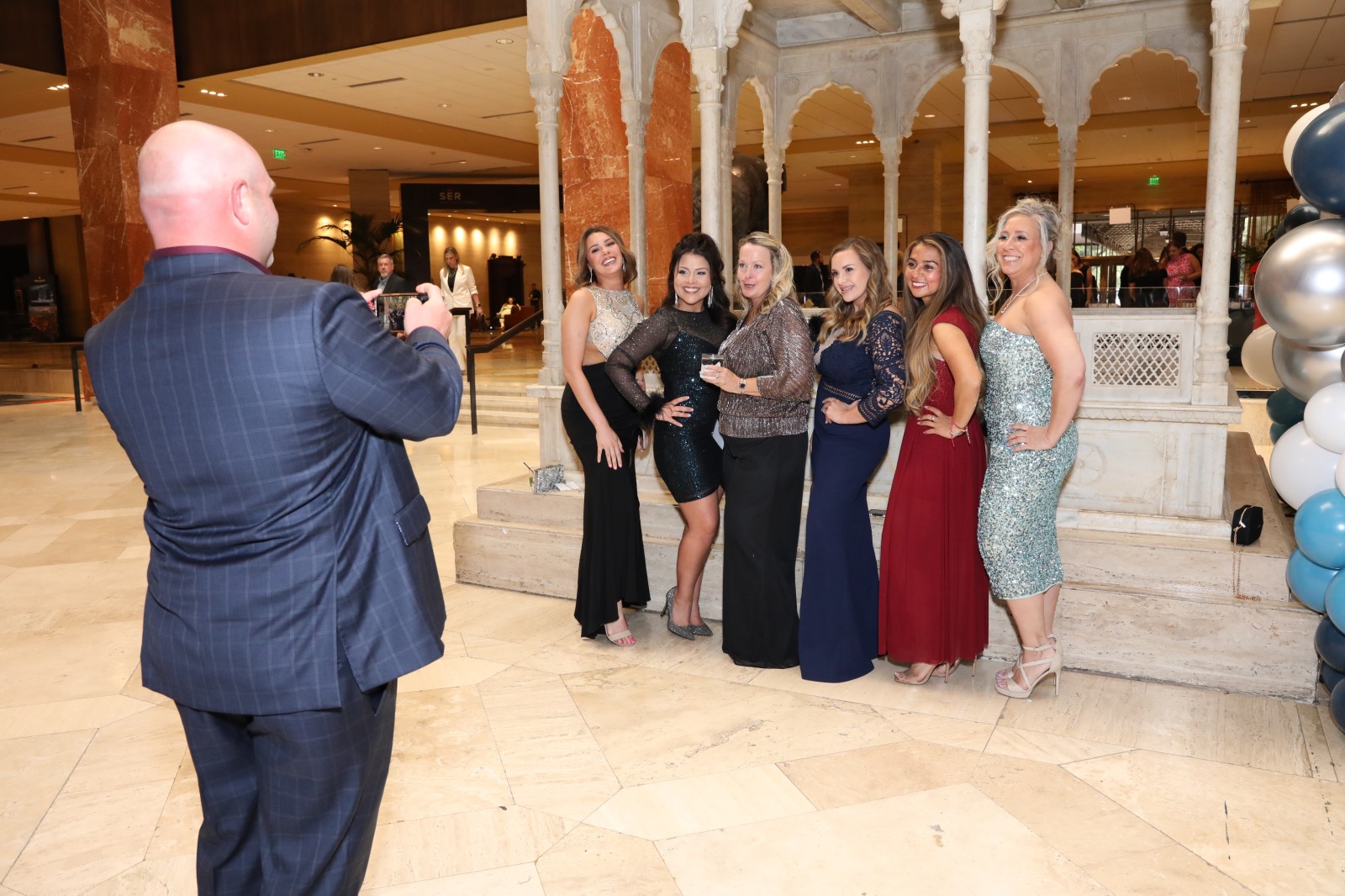Women Posing in Front of Sapphire Block Letters