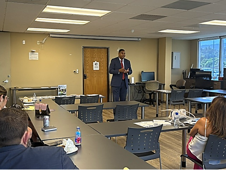 John McKinney addressing real estate professionals at an AAGLA-sponsored fundraising event