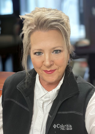 A person with blonde hair wearing a black vestAI-generated content may be incorrect.
