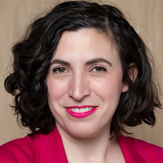 A person with dark hair wearing a pink jacketAI-generated content may be incorrect.
