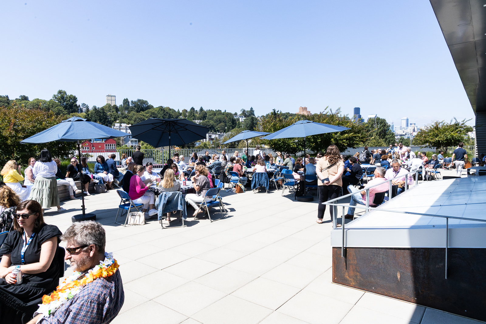 Conference attendees relaxing on a rooftop patio