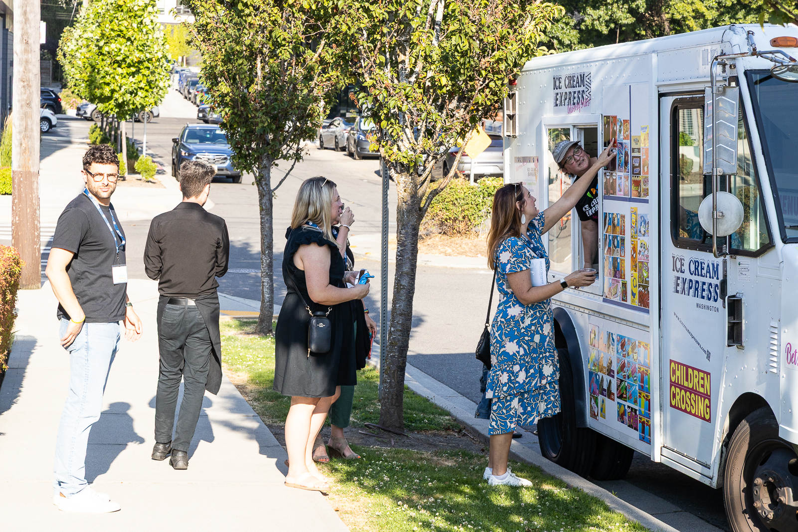 Several people approaching an ice cream truck outside