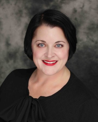 Professional headshot of woman wearing black top