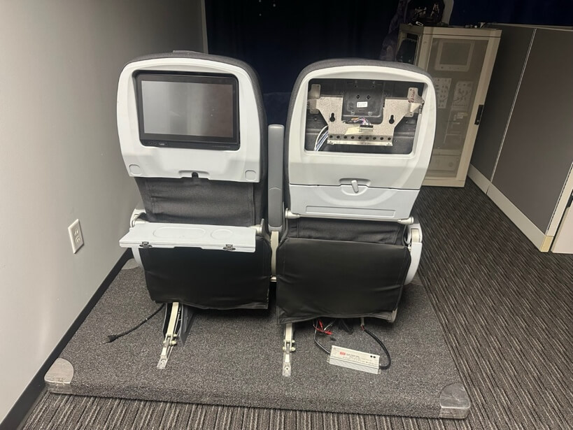 Two chairs with a screen on the backAI-generated content may be incorrect.