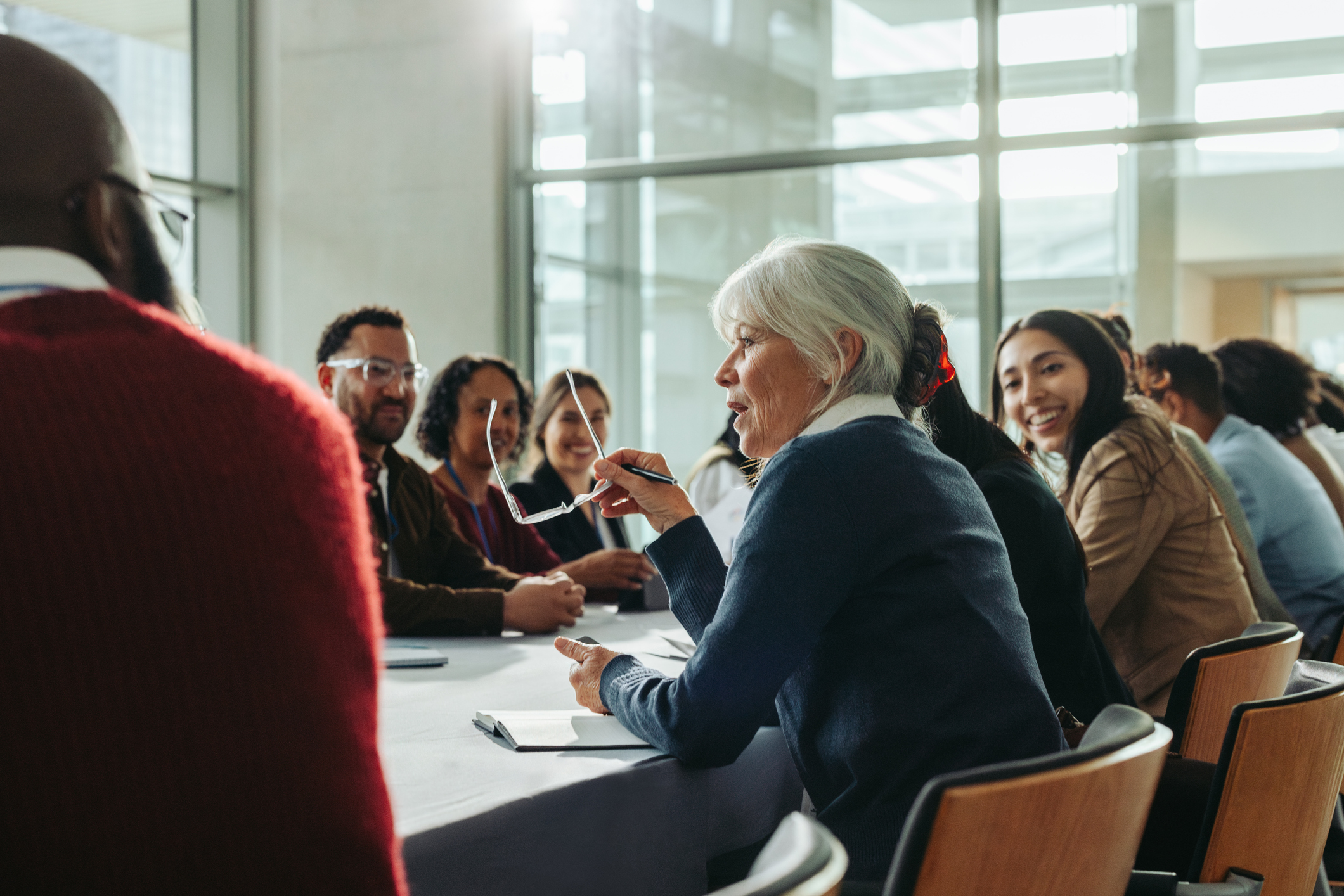 Campus leadership team in discussion around a conference table