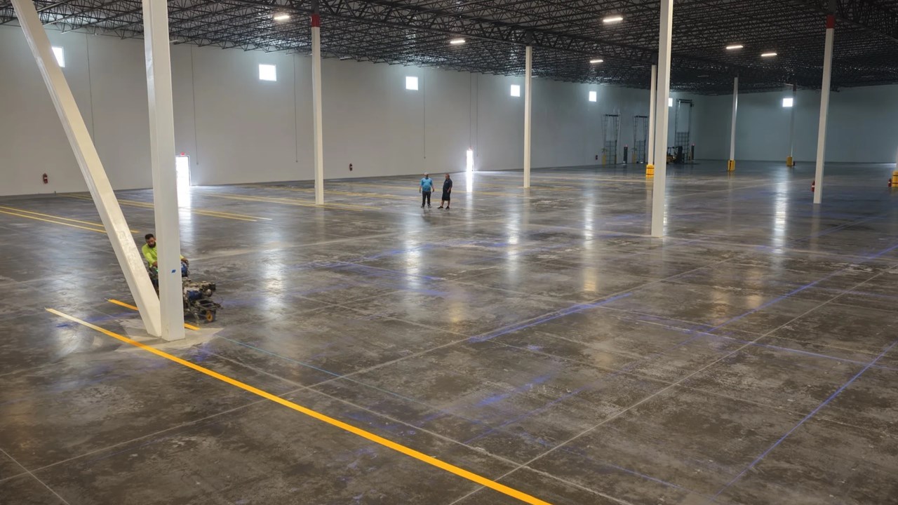 Radiant Striping crew striping yellow safety lines in 1-800-PACK-RAT warehouse, Tampa