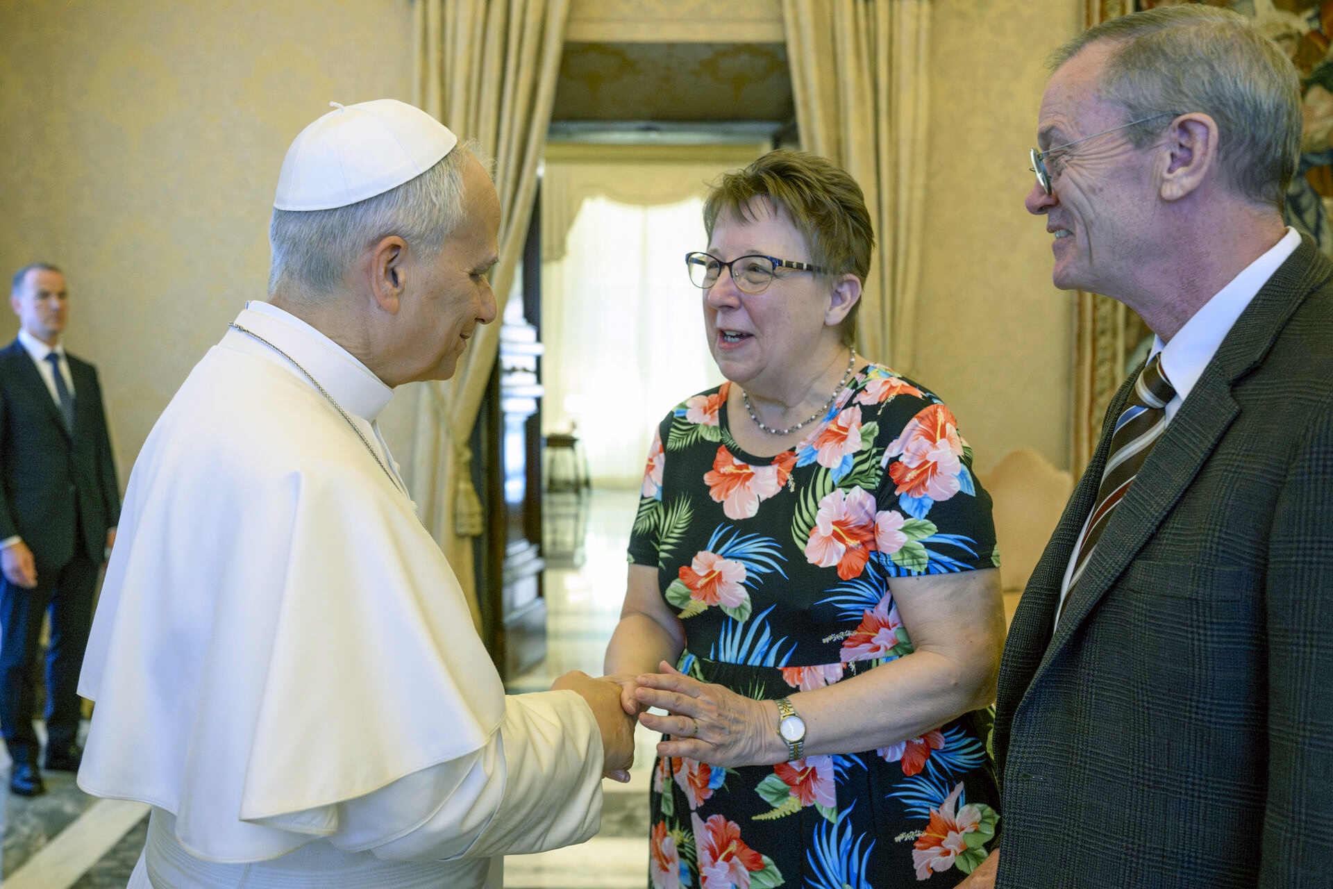 Pope Leo greets Helen Osman and her husband, John Osman, at her investiture