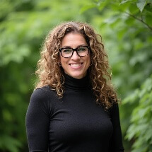 A person wearing glasses and a black turtleneckAI-generated content may be incorrect.