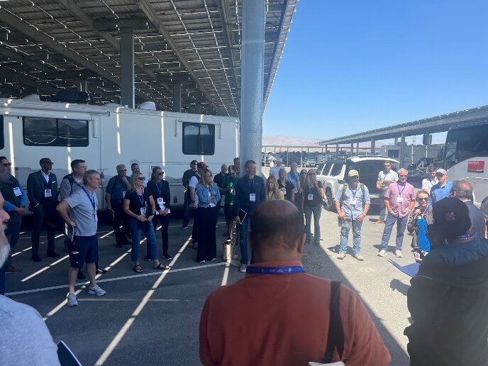 A group of people standing in a parking lotAI-generated content may be incorrect.