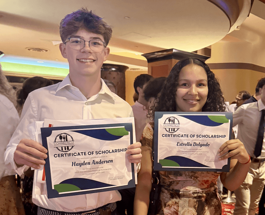 Scholarship winners Hayden Anderson (left) and Estrella Delgado (right) receiving their scholarships at Norwich Free Academy's Award Night on June 10th, 2025.