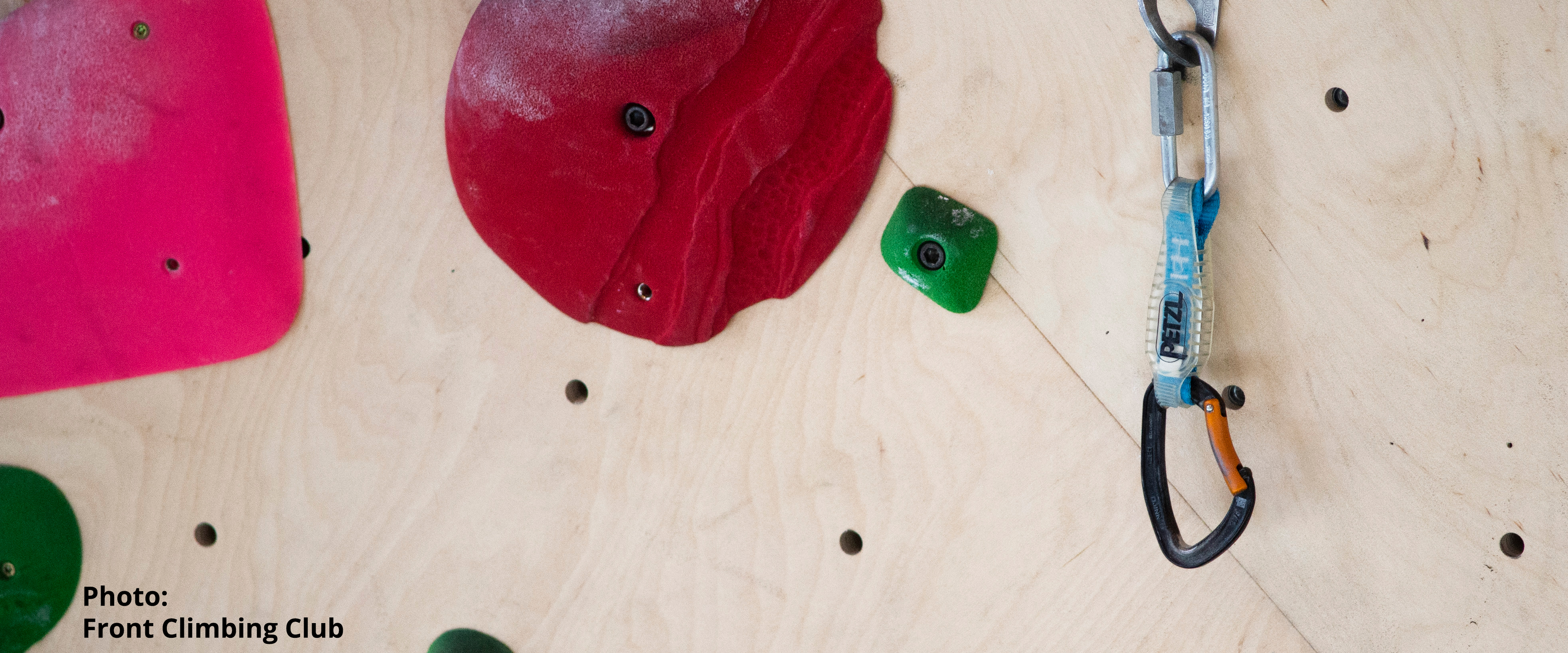 A route in a climbing gym with a quickdraw