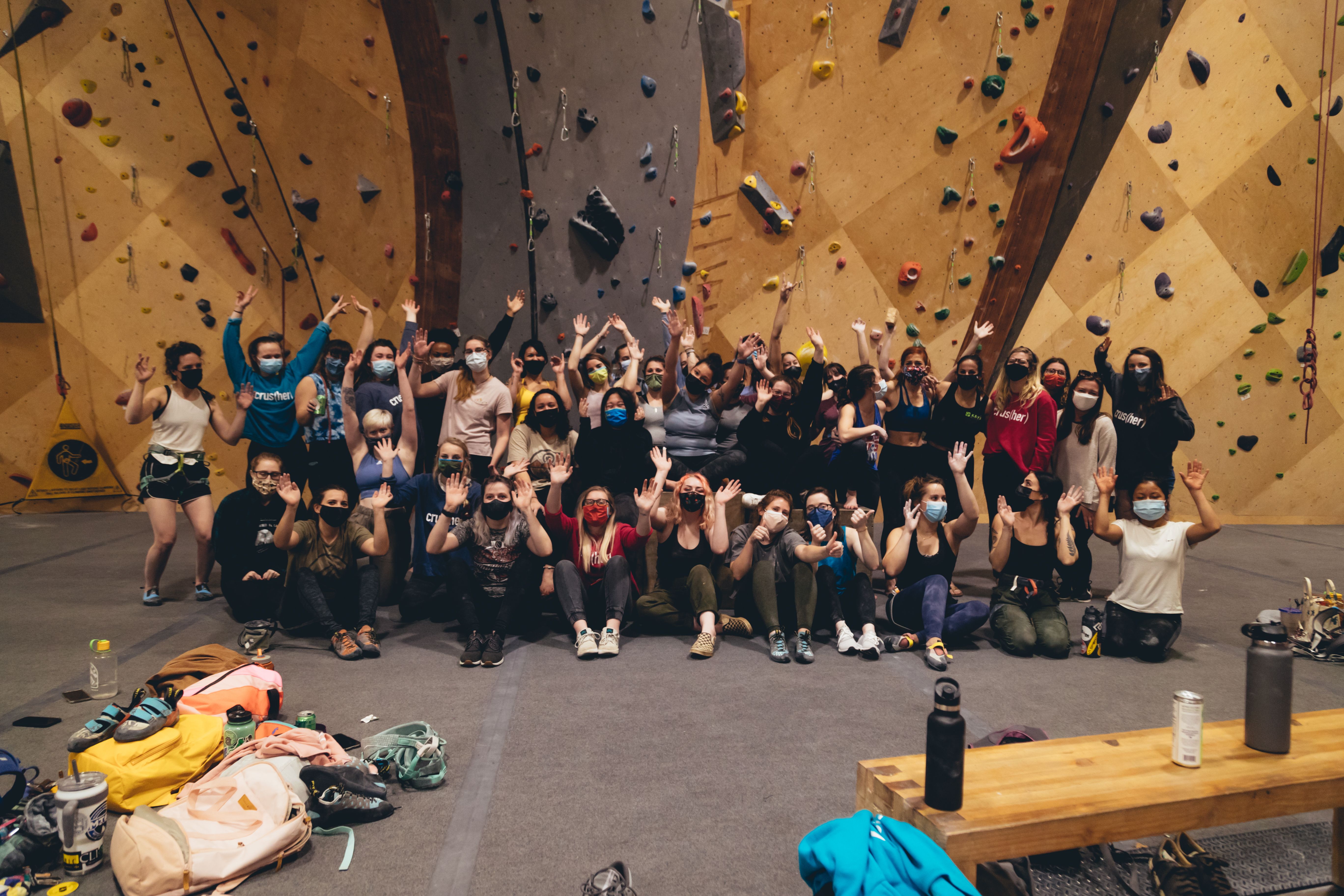 Group indoor climbers wearing masks