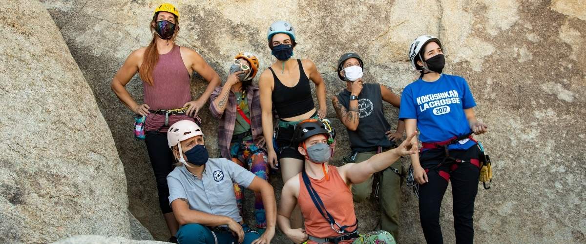 Outdoor rock climbers wearing masks