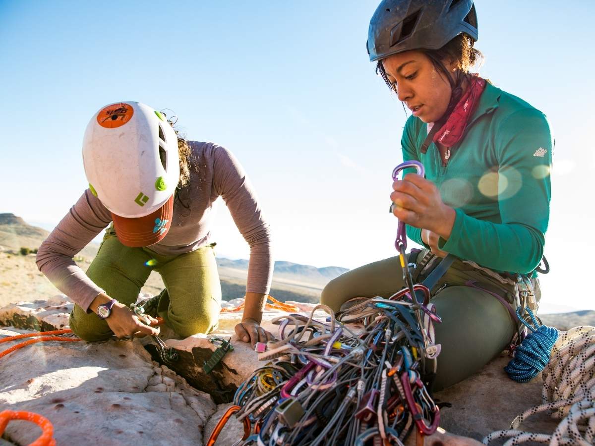 two rock climbers working with trad gear outside