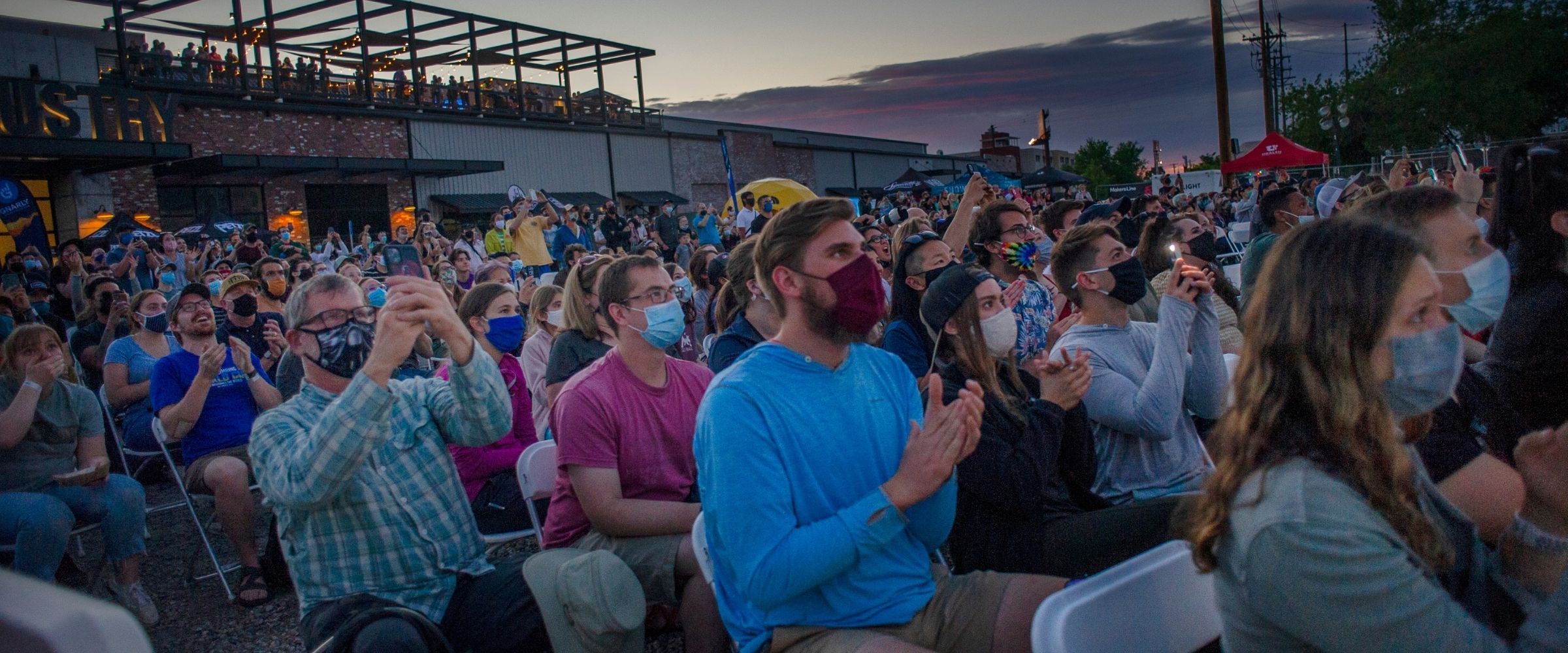 Fans cheering in masks outdoors