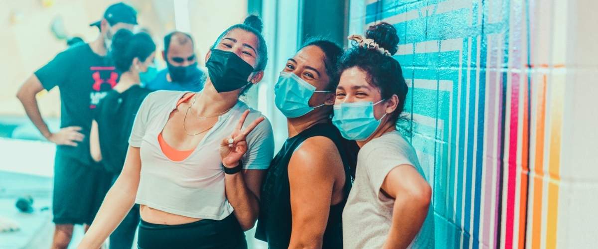 Group of young rock climbers wearing masks