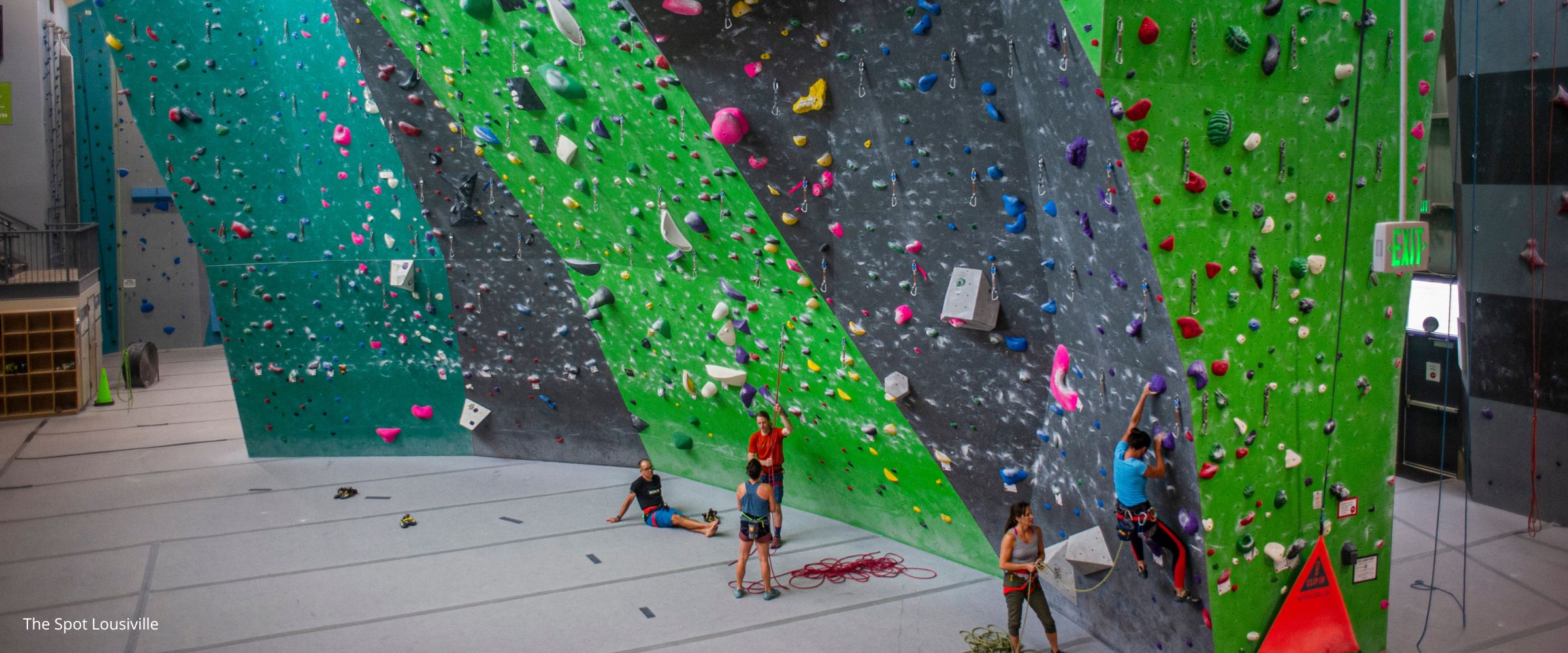 People lead climbing inside indoor climbing gym