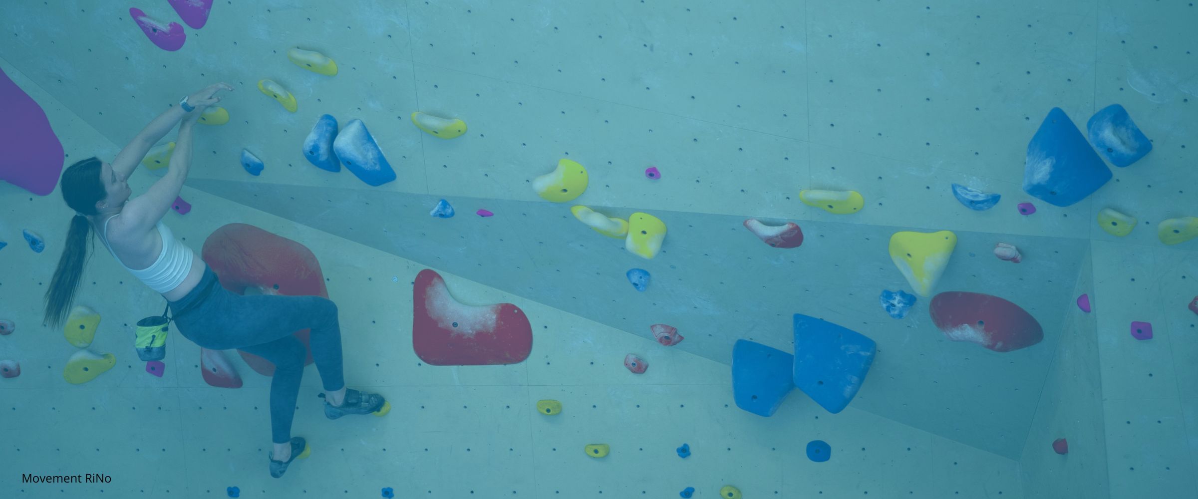 Woman climbing in indoor climbing gym