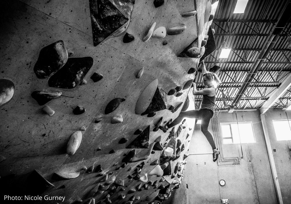 Lauren Watson climbing indoors at a cimbing gym