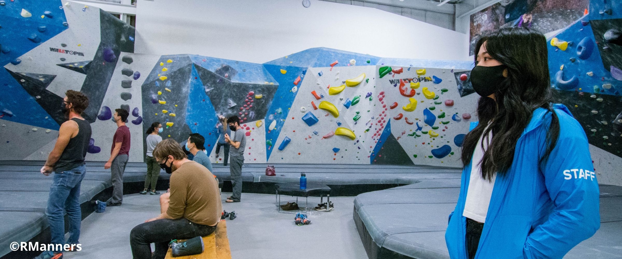 Staff assisting in indoor climbing gym