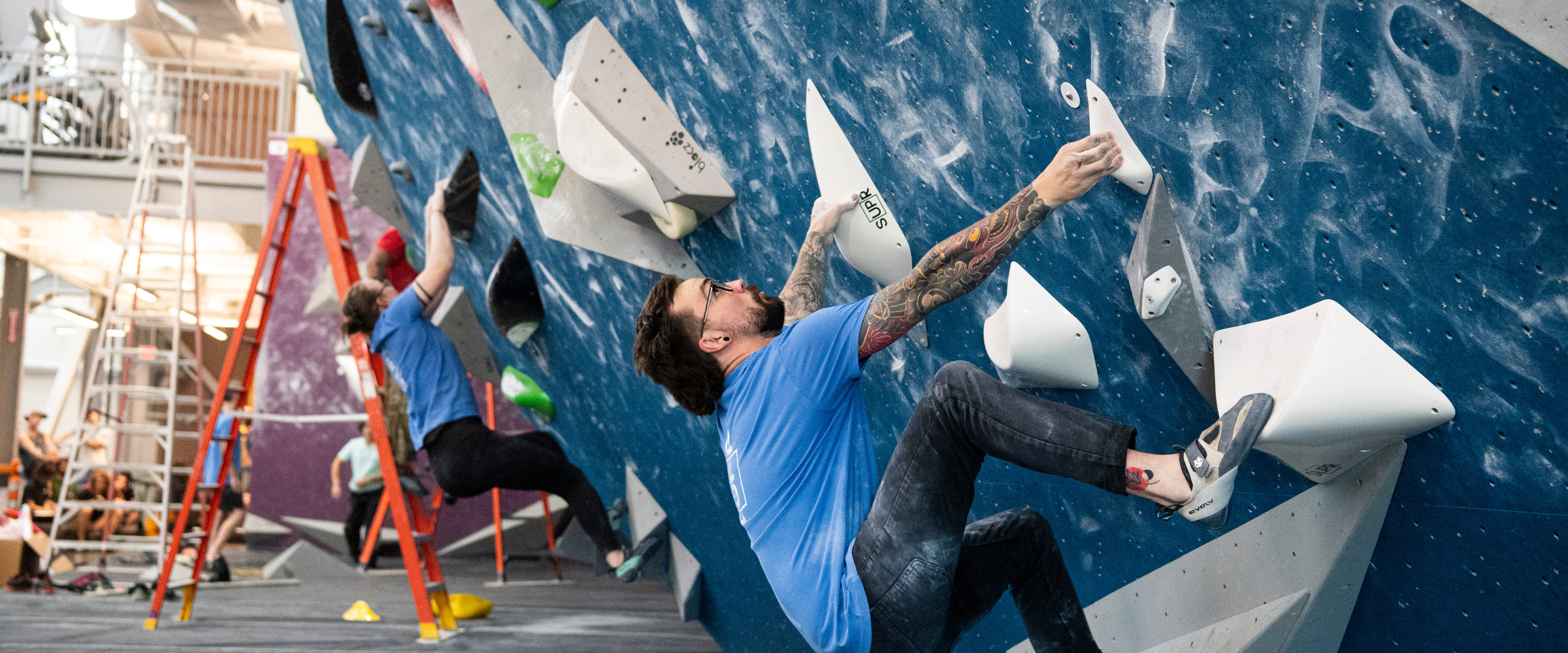 People climbing inside indoor climbing gym