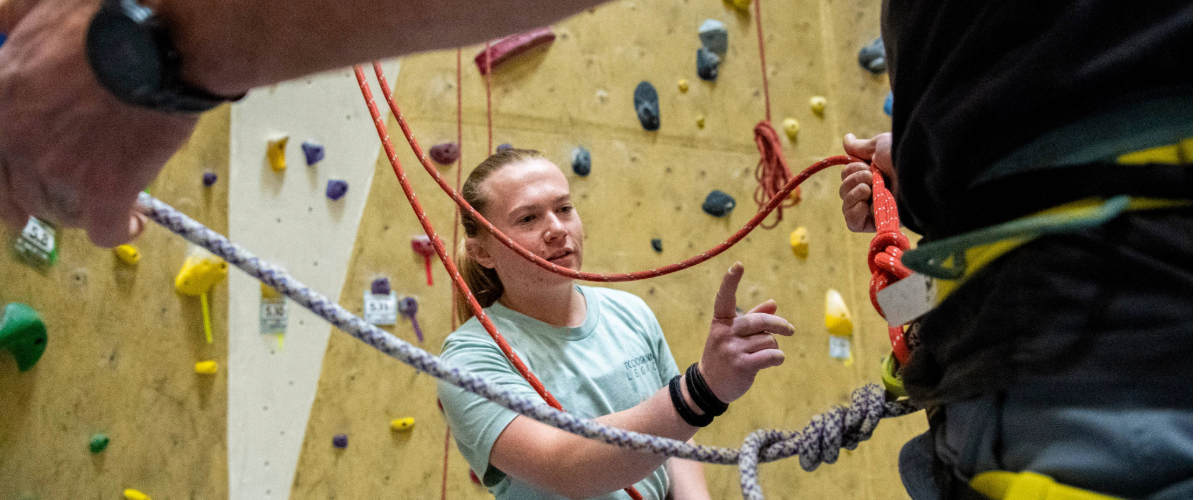 Person giving certification in indoo climbing gym