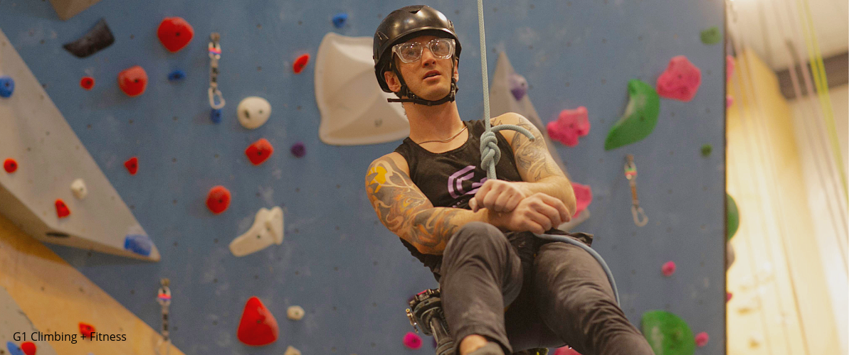 Person wearing eye protection in indoor climbing gym