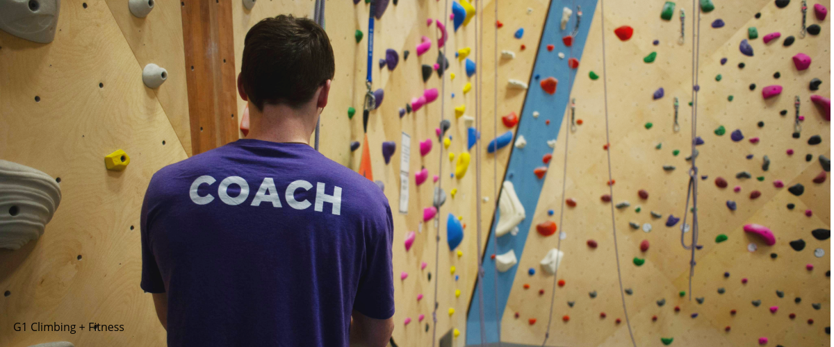 Coach in indoor climbing gym