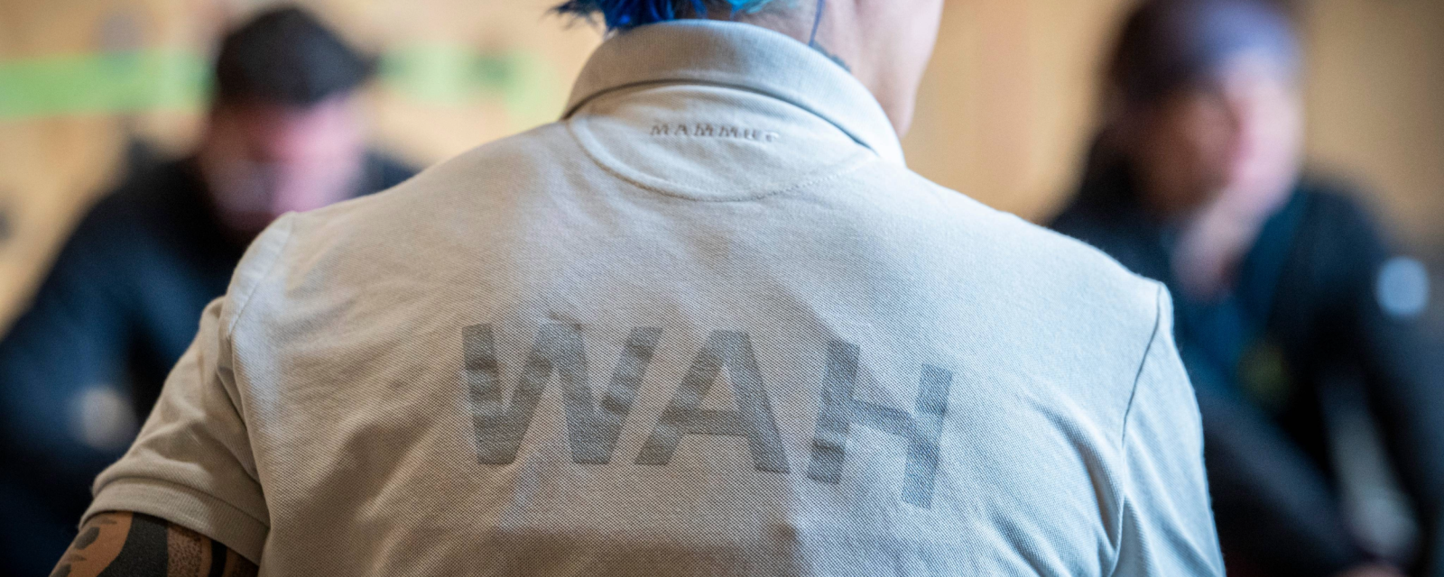 A person wearing a WAH shirt