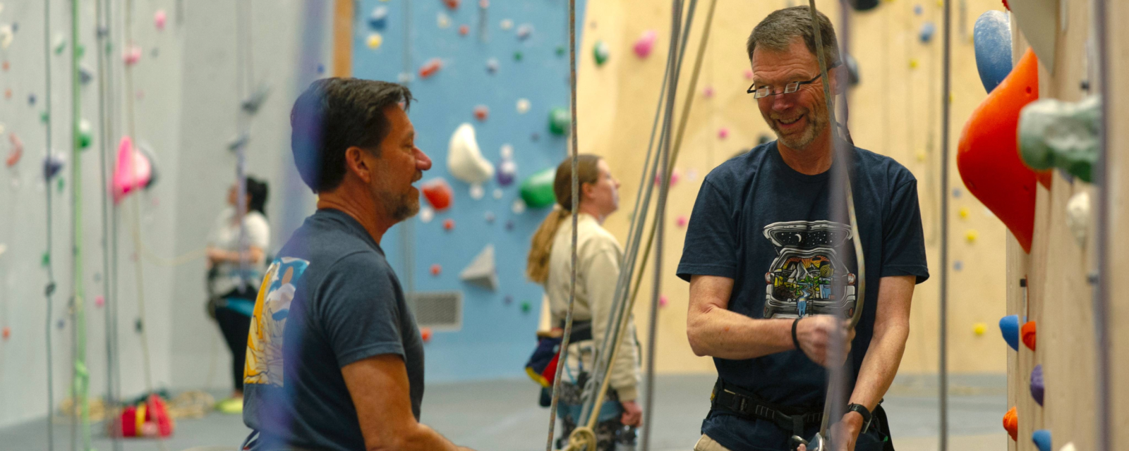 Two people in an indoor climbing gym