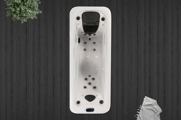 A white bathtub with a black cover and a treeDescription automatically generated with medium confidence