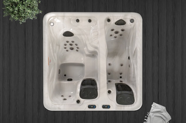 A white hot tub with black handlesDescription automatically generated with medium confidence