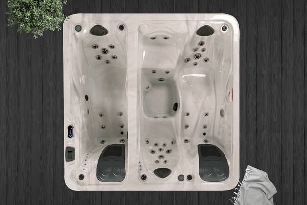 A white hot tub with black handlesDescription automatically generated with medium confidence