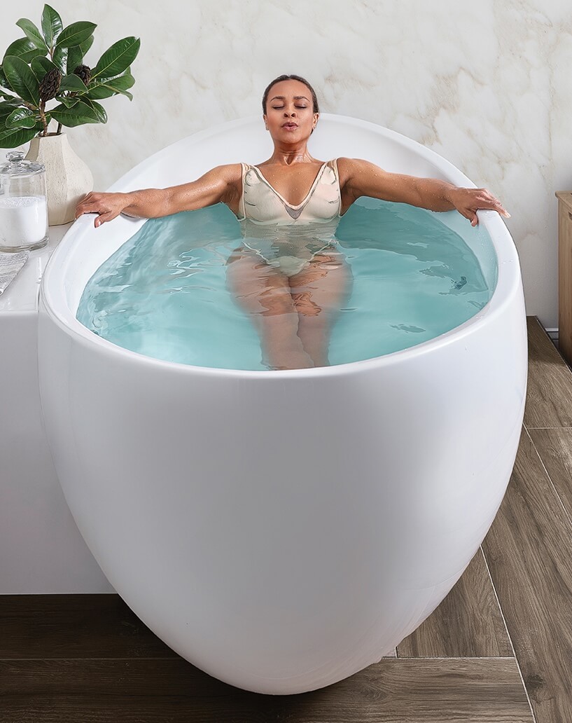 A person in a white bathtubDescription automatically generated