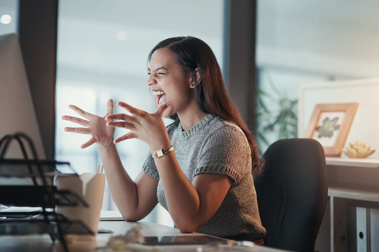 Woman yelling in frustration with hands up