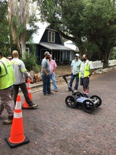 A group of men standing on a brick road with a hoverboardAI-generated content may be incorrect.