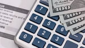 A calculator and money on a paperAI-generated content may be incorrect.