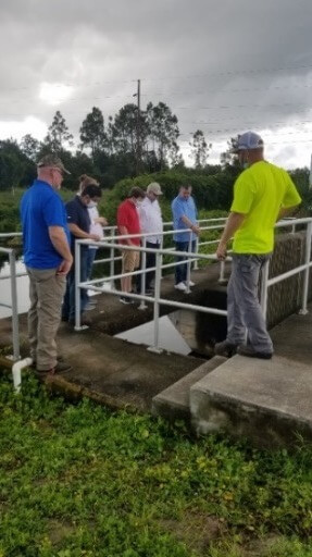 A group of people standing on a railingAI-generated content may be incorrect.
