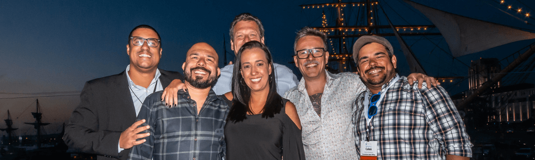 photo of 6 smiling people at a GALA conference dinner
