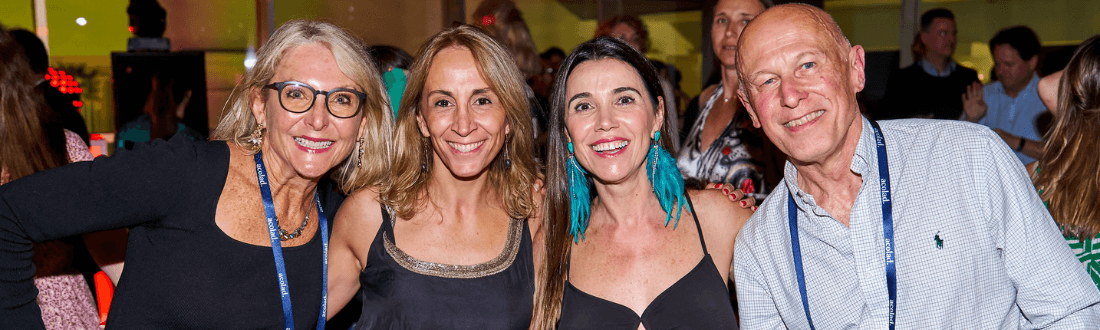 Photo of 4 smiling people on the dance floor at a GALA Dinner