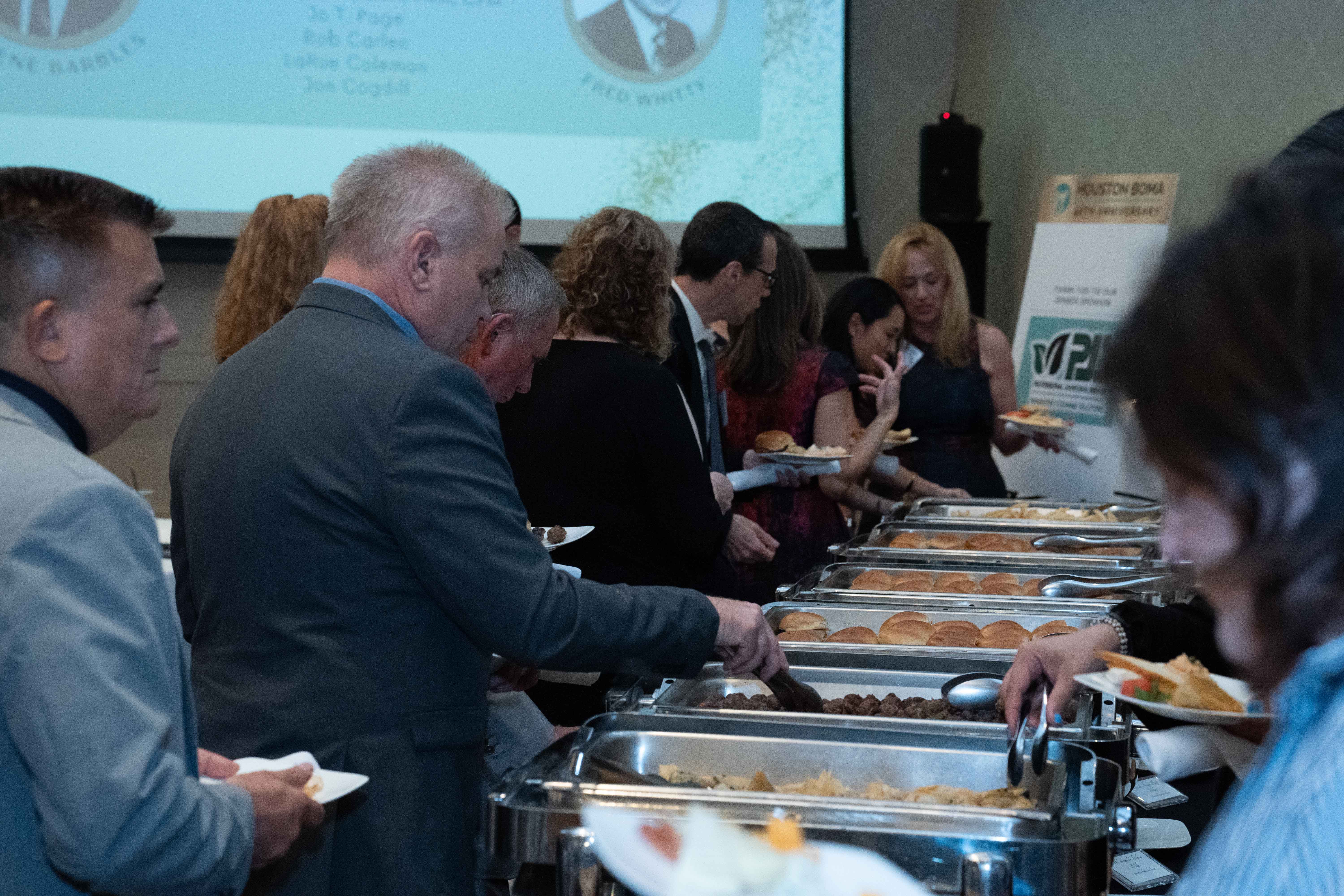 Attendees visit the buffet sponsored by PJS.