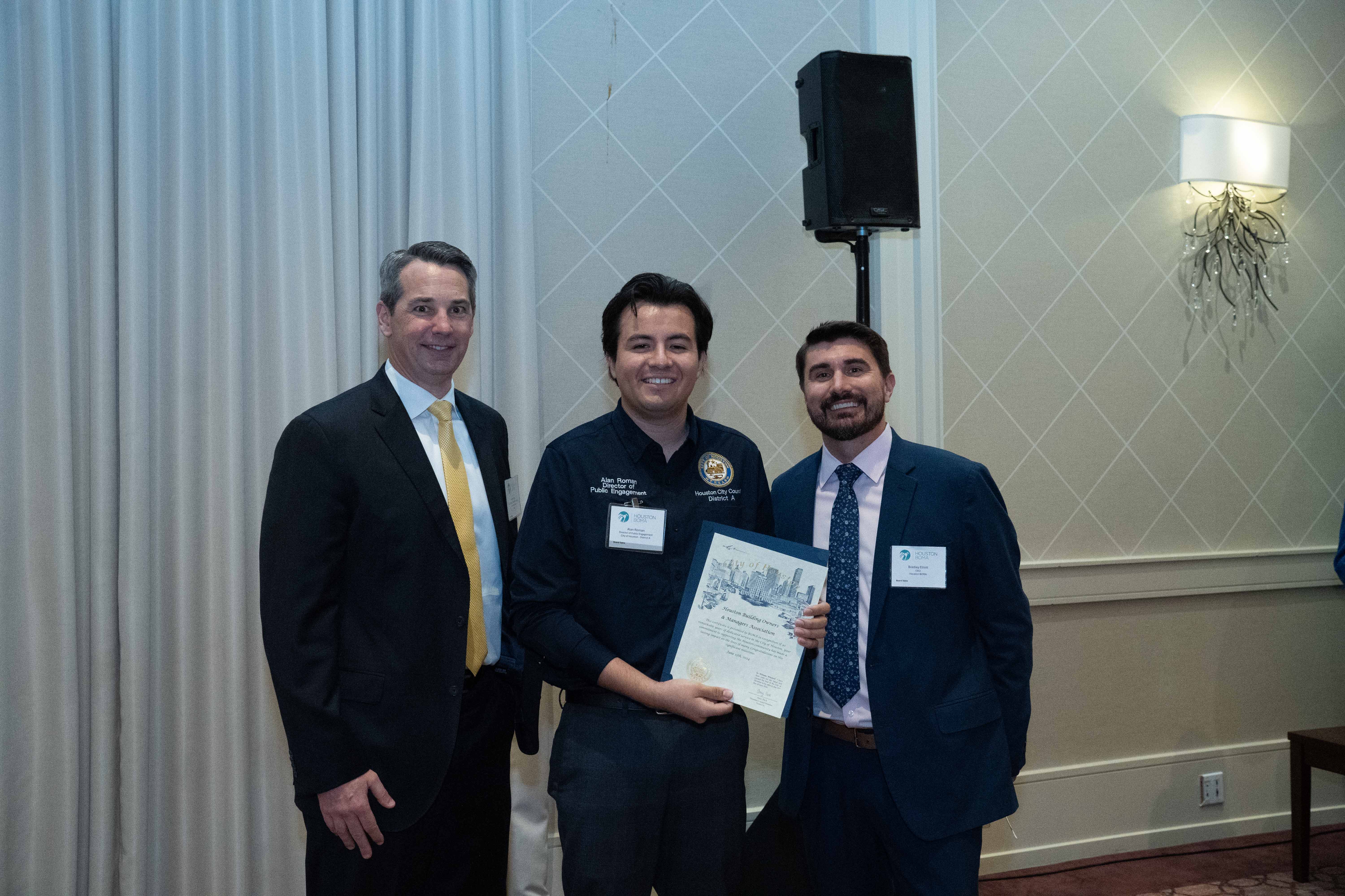 President Adam Rose, Hines, and CEO Bradley Elliott with Alan Roman of Houston City Council District A office.