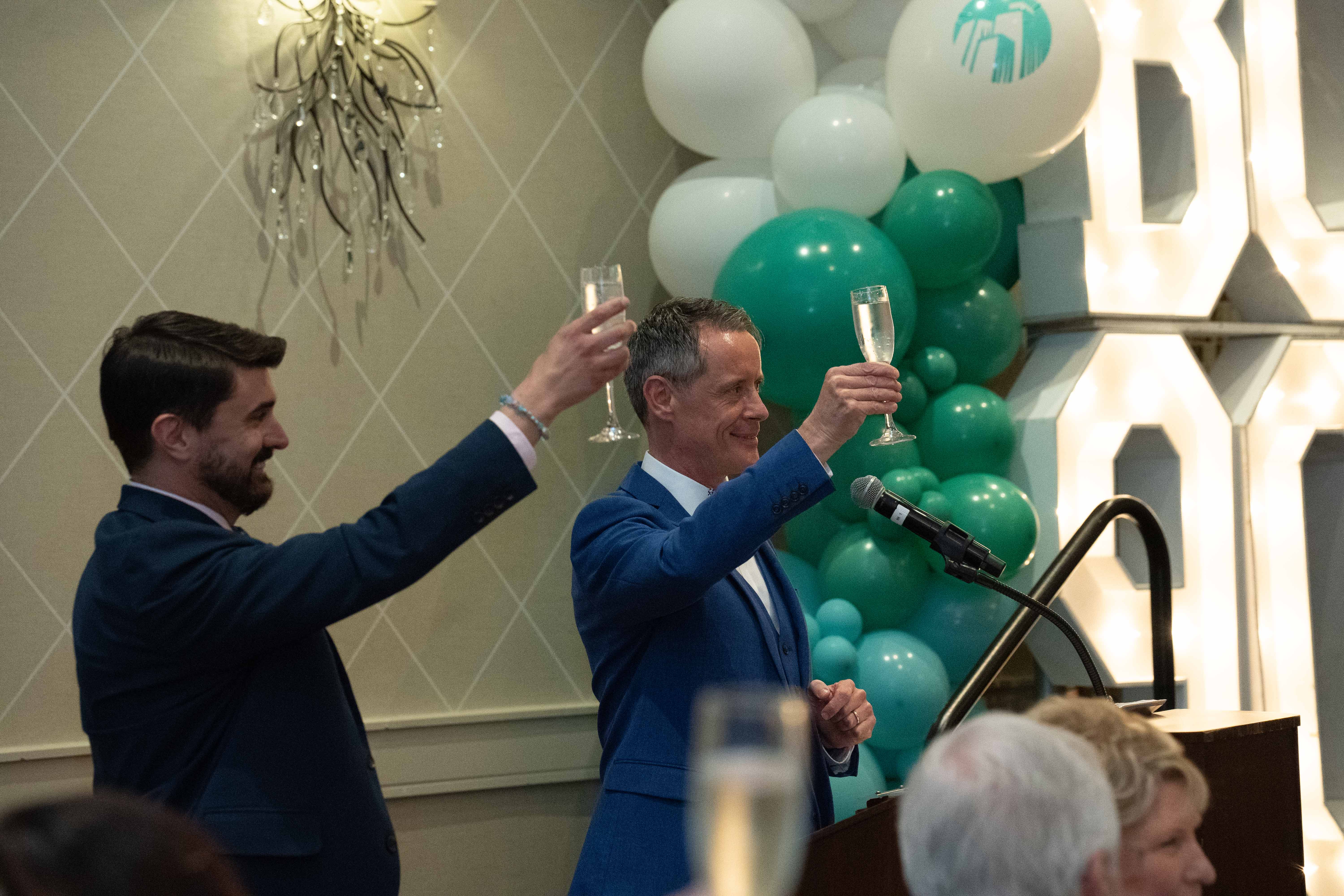 CEO Bradley Elliott and Master of Ceremonies Peter Merrett share a toast.