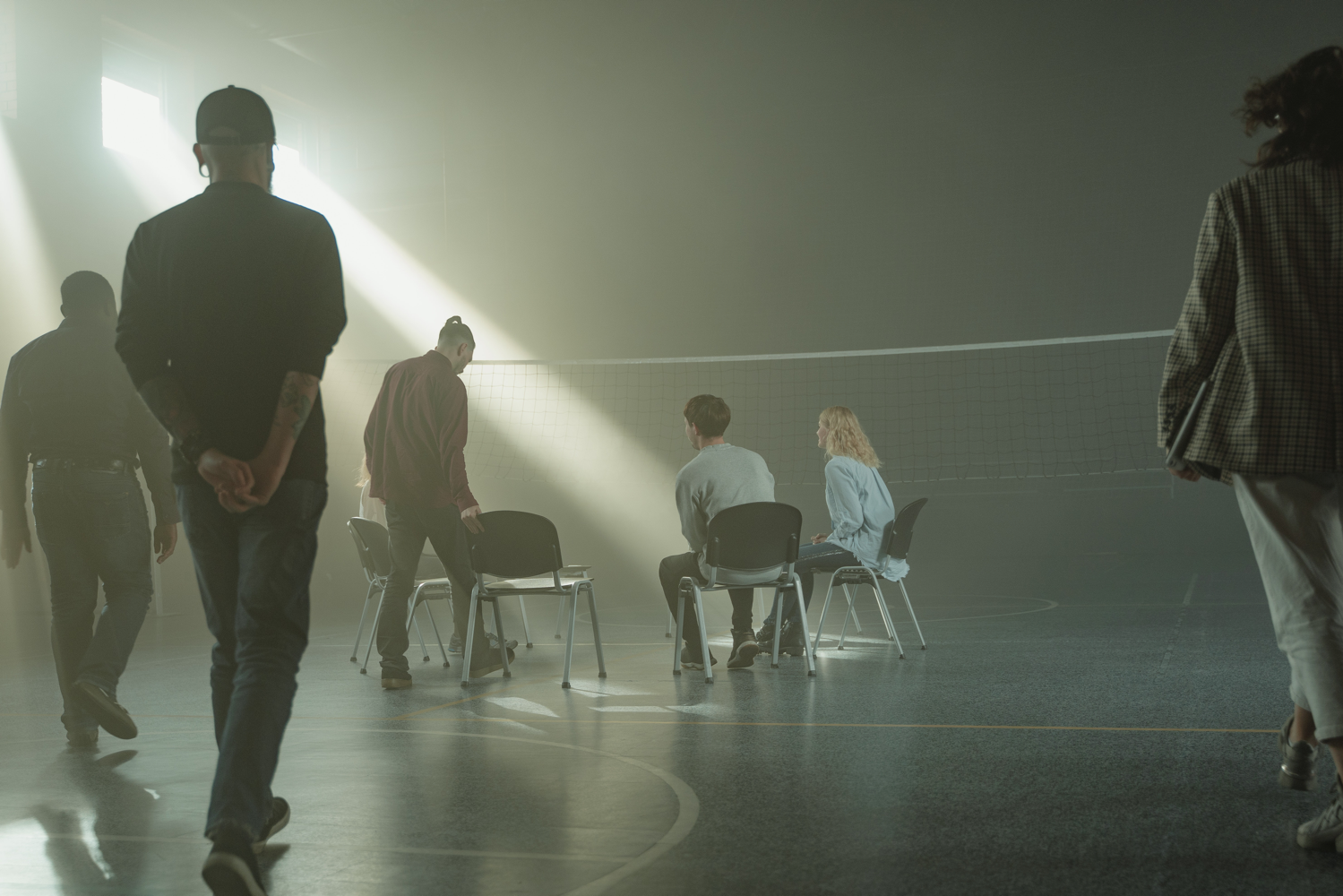 multiple people walking towards chairs