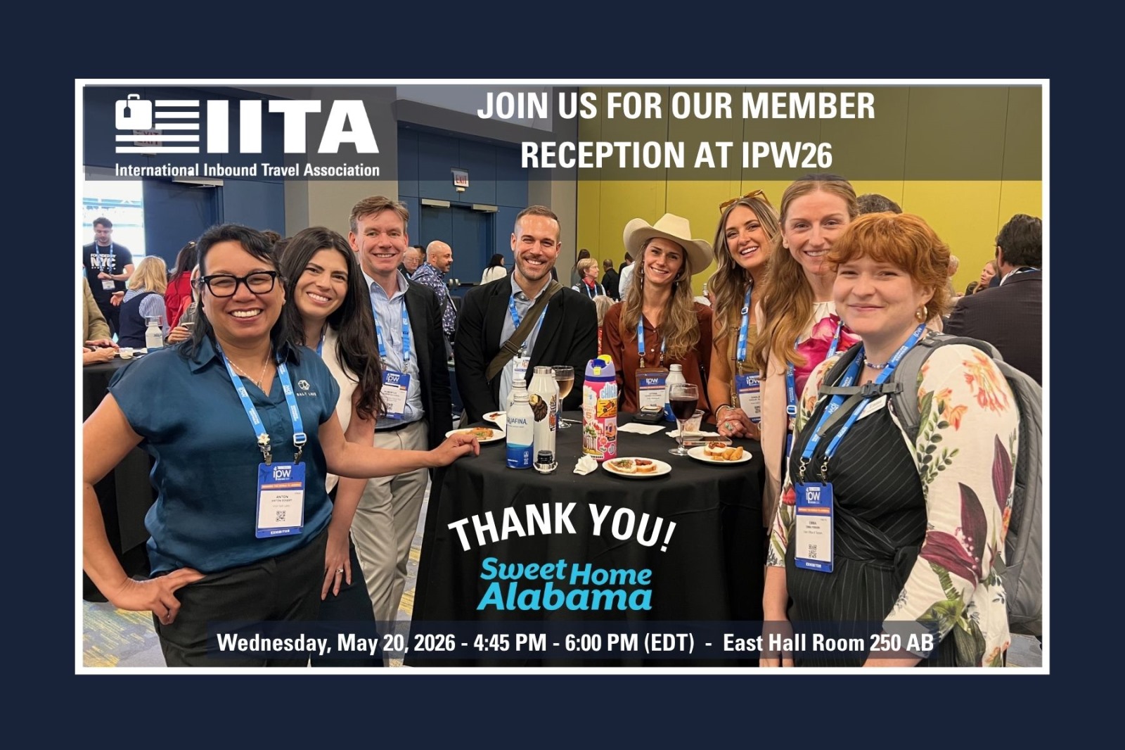 group of IITA members at reception with invite to 2026 event