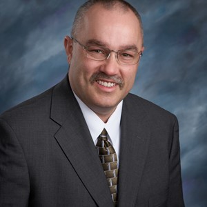 Dr. Chris E Mills