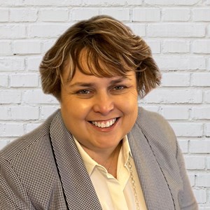 A person smiling at the cameraAI-generated content may be incorrect.