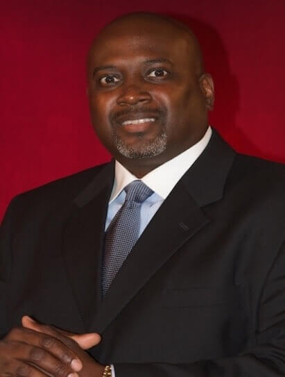 A person in a suit and tieDescription automatically generated