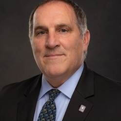 A person in a suitAI-generated content may be incorrect.